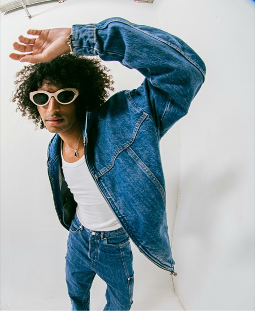 A dancer mid-move in double denim